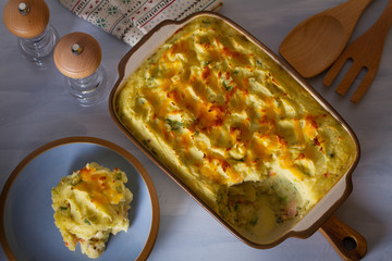Creamy fish pie: salmon, cod, smoked coley, creamy sauce and cheesy potato topping. View from above, top view