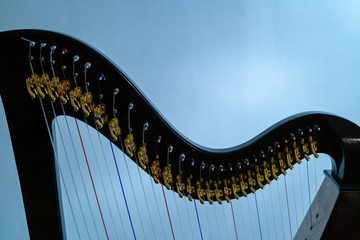 The strings of the harp close-up on a blue background.