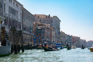 San Marco / Venice / Italy - April 17, 2019: View of Grand Canal with tourists in gondolas and old colorful buildings