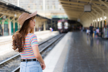 Beautiful  traveller posing whike waiting for the train at the station