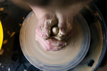 Fototapeta premium The master works behind the potter's wheel