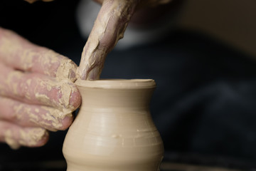 The master works behind the potter's wheel