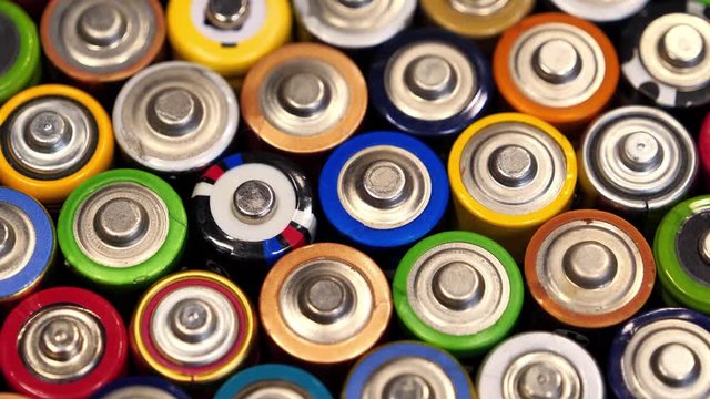 A lot of multicolored used batteries
