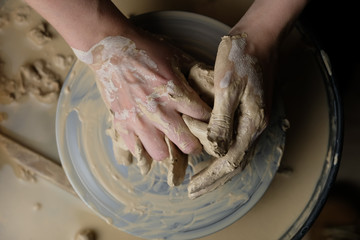 The master works behind the potter's wheel