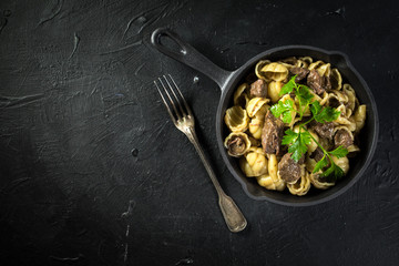 Italian pasta shells with beef sauce.