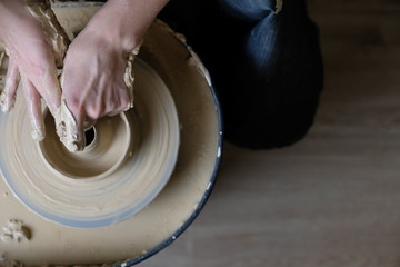 The master works behind the potter's wheel