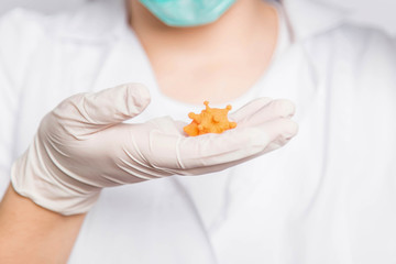 Closeup virus mock up in doctor's hands, concept of scientific research in the laboratory.