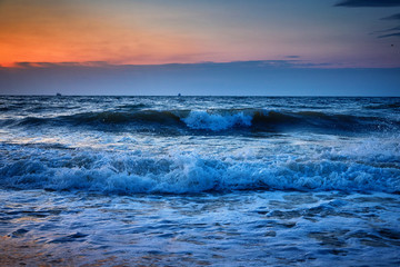 Naklejka na ściany i meble Sea waves and Beautiful dawn sunrise at sea. Seascape.