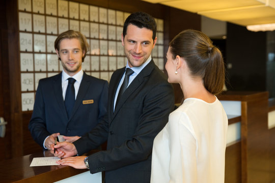 Businesswoman and Businesswoman checking out in hotel reception.