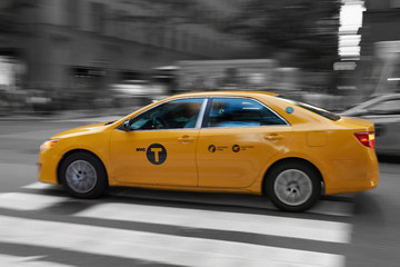 Fototapeta na wymiar Yellow cab, New York wih motion blur mixed colour and black and white