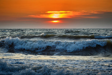 Naklejka na ściany i meble Sea waves and Beautiful dawn sunrise at sea. Seascape.