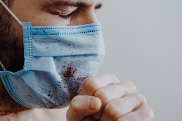 portrait of a young, sick man dressed in a medical mask to protect weak immunity from viruses that...