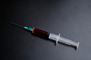 A small syringe into which a hollow, sharp-pointed bevel-cut needle is inserted and is used to inject medicinal substances into tissues or organs.