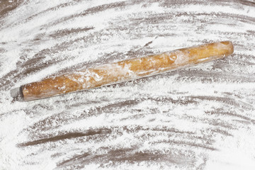 Kitchen rolling pin on flour. Background. To cook