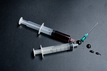 A small syringe into which a hollow, sharp-pointed bevel-cut needle is inserted and is used to inject medicinal substances into tissues or organs.