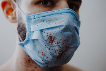 portrait of a young, sick man dressed in a medical mask to protect weak immunity from viruses that...