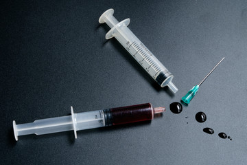 A small syringe into which a hollow, sharp-pointed bevel-cut needle is inserted and is used to inject medicinal substances into tissues or organs.