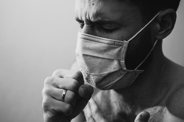 portrait of a young, sick man dressed in a medical mask to protect weak immunity from viruses that can kill