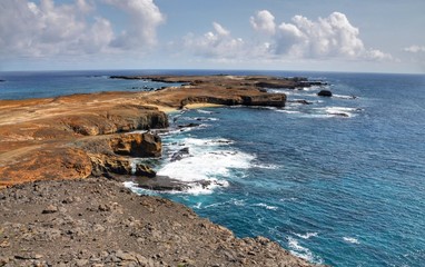 Plateau on the islet of Djeu with crashing waves on both sides