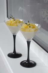 Panna cotta with pear and orange in a glass