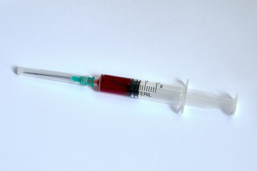 A small syringe into which a hollow, sharp-pointed bevel-cut needle is inserted and is used to inject medicinal substances into tissues or organs.