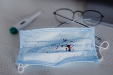 medical mask with bloody cough marks