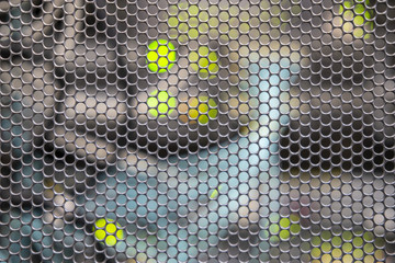 Metal grid background with blurred background and cables