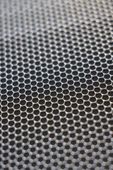 Background metal surface with round lattice holes, texture