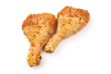Marinated chicken drumsticks, isolated on white background
