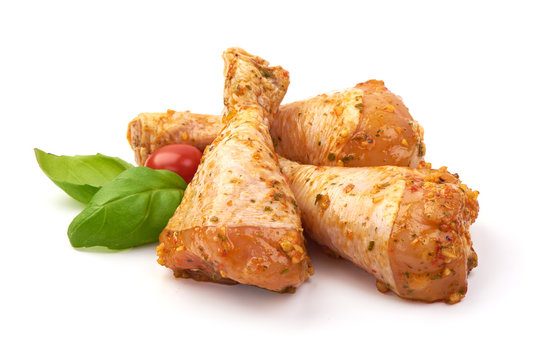 Marinated chicken drumsticks, isolated on white background