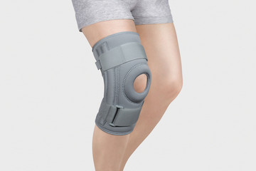 Knee Support Brace on leg isolated on white background. Orthopedic Anatomic Orthosis. Braces for...