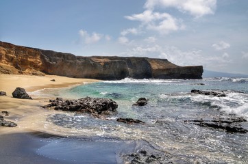 Merging of white and black sand beach found on the tiny islet of Djeu in the Republic of Cape Verde off the west coast of Africa