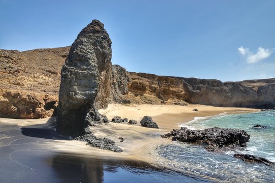 Pointy leaning boulder on a beach in Djeu Cabo Verde, part of a chain of islets known as "Ilheu dos Rombos".