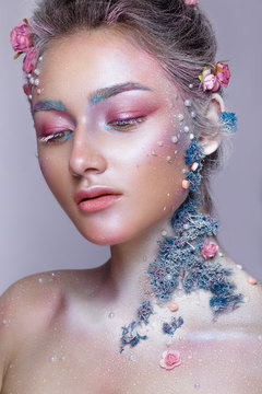 Beautiful girl in the image of a sweet fairy with art make up. Creative look.