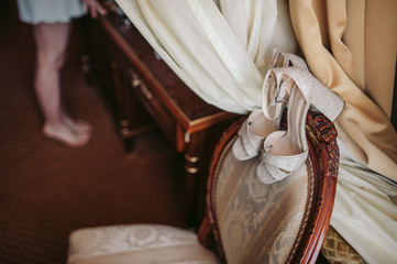 Beautiful wedding shoes and bride's legs