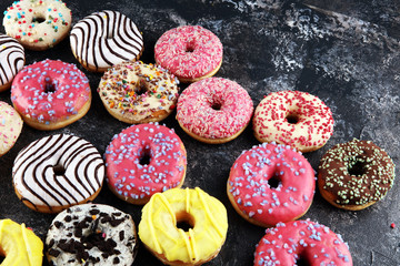 donuts in different glazes with chocolate, sprinkles and stripes