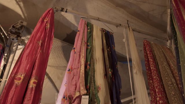  Cloth on indian textile market hanging from pole 