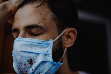 portrait of a young, sick man dressed in a medical mask to protect weak immunity from viruses that...
