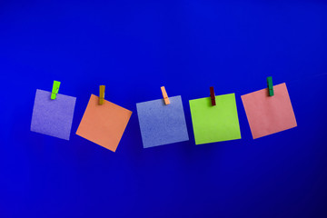 stickers for notes on a rope hitched with colorful clothespins