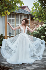 Fototapeta premium Beautiful bride. Woman waving dress. Sexy girl with professional make up