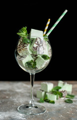 Mint and delicious marshmallows in a beautiful glassy glass with sprigs of fresh mint.