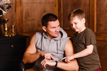 man and child look at the clock