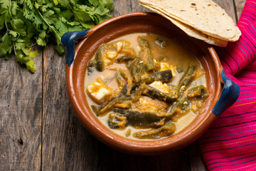 Mexican poblano pepper rajas and panela cheese on wooden background