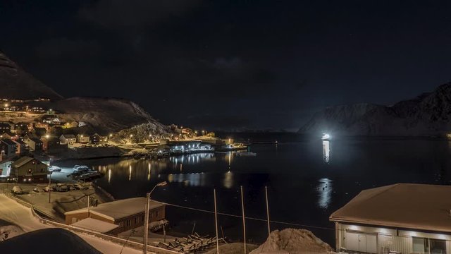 Timelapse of a bay in the north of Norway with a boat coming in before snowfall