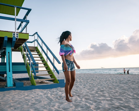 Miami Beach, Woman At An Lifeguard Hut At Miami Beach Florida, Girl In Dress On The Beach With Bikini