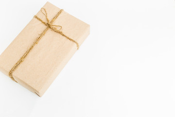 gift box with natural paper lies on a white background. place for text. holiday concept. Place for...