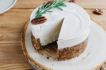  cake with cream. Pecan cake on a wooden background. Raw dessert. Food photography