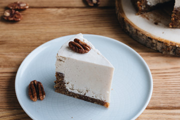  cake with cream. Pecan cake on a wooden background. Raw dessert. Food photography