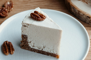  cake with cream. Pecan cake on a wooden background. Raw dessert. Food photography