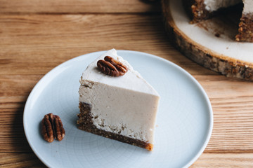  cake with cream. Pecan cake on a wooden background. Raw dessert. Food photography
